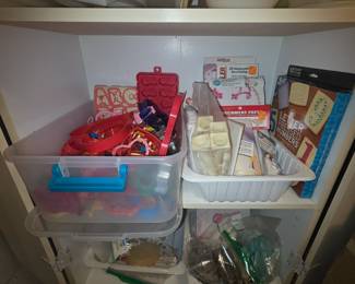Lots of cookie cutters, cake decorating items