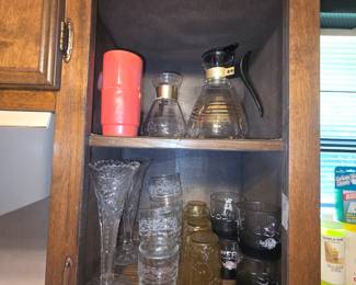 Kitchen - cups, coffee containers, glasses in bottom section including Razorback ones on right