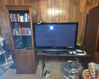 Bookcase with speakers & more books small table holding TV & miscellaneous