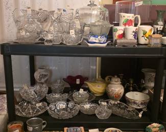 Top shelf: Glass collectibles including stand cake stand, various pressed glass items, bowls, vases, candy dish on top shelf! 5 piece pitcher & glasses set. Bottom shelf - canisters, more pressed glass, tea pot, & coasters !