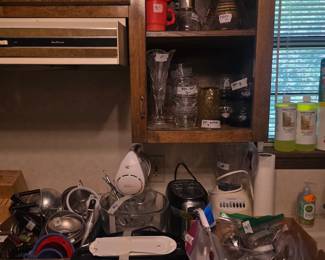 On left is George Fireman grill, miscellaneous gadgets, coffee maker, blender - all on cabinet. Shelves have cups& carafes, glasses!