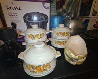 Kitchen “serve & store” set of stoneware bowls with lids, leaf shaped bowls , metal blue pitcher in back