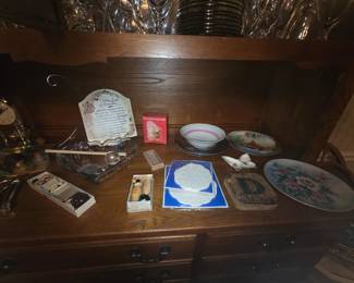 Items in and on China cabinet includes Anniversary placque, butterfly, large round platter, doilies, bowls, & miscellaneous other itemsv