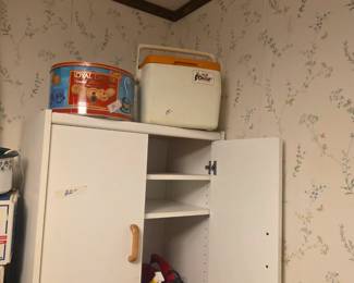 Ice chest & tin on top of cabinet; other items inside