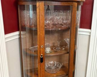 BEAUTIFUL ANTIQUE CURIO CABINET WITH KEY AND A NICE SELECTION OF CRYSTAL.