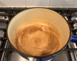 D43 - $50. Le Creuset Sauce Pan #20. 2 qt. Hollow handle. Outside is in great condition. Inside has staining but enamel is intact.