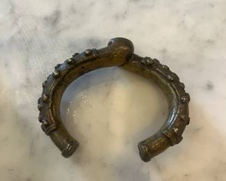 Vintage bronze currency bangle for sale during in-person shopping