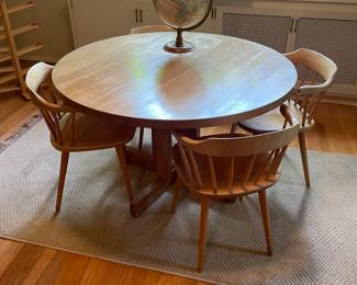 $250 Game table with four chairs. 47” dia. X 29”H. (As found)