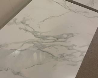 Close up of the marble top on the pair of console tables.