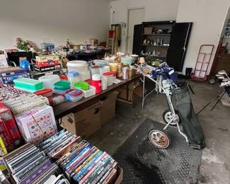 The garage is full of puzzles, DVDs, tools, shovels, Ridgid miter saw, golf clubs, kitchen items.
