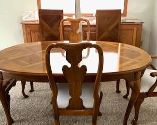 Thomasville dining table 2 side chairs, two captain chairs, two additional leaves, and protective cover.