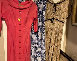 The 1970s dress in the middle says MCP - male chauvinist pig. It has a few holes in the back, but I couldn't bring myself to toss it! The dress on the right is covered with MCM lamps, or maybe an old coffee grinder, hard to tell - too cute. The pink dress, from the early 1950's, is so elegant