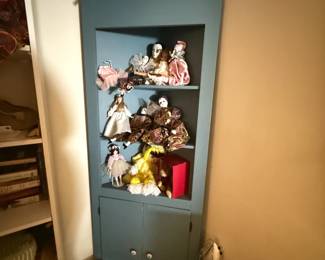 corner cabinet , porcelain dolls, madame alexander dolls