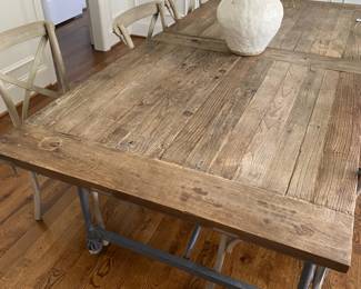 A98 - $1250. Restoration Hardware Flatiron Dining Table. Includes 6 chairs. Measures 39.5" x 84" x 30" tall. Overall good condition and very sturdy. There are a few water marks on the top and one where they sanded it out a bit. Part of the RH charm!