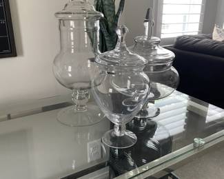 A43 - $25. Set of 3 Lidded Canisters. 17", 12" & 10" tall. One jar has a chip noted the others look good.
