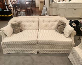 White loveseat with pillows
