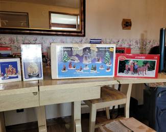 Many Christmas Village items with boxes.