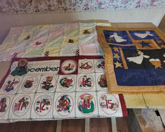 Quilted and embroidered wall hangings and baby blanket.