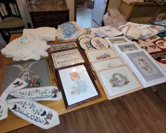 Embroidery pictures and table coverings. Crocheted doilies and pillowcases.