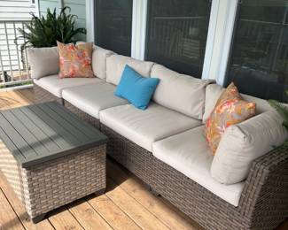 Outdoor sectional and storage table. Additional set of cushion covers included.