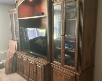 Electronics not for sale. Custom solid wood entertainment center with lighting. This piece is made in 6 parts for easy moving. Seeded glass doors and additional shelves for center section.