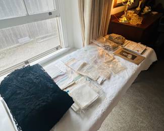 Just the tip of the iceburg antique lace, crochet, tablecloths, napkins, doilies, hankies, pieces of lace. Black Chantilly lace mourning dress and other pieces.