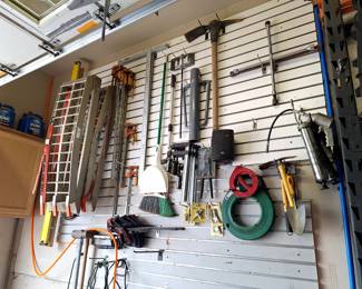 Shop Wall of tools Number 3 pickaxe, ramps, post hole digger, and more.