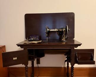 Vintage National Sewing Machine. Has a knee lever instead of a foot pedal to control the speed .