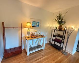 gun rack , solid handcrafted entryway table , bookshelf, floor lamps , candles 
