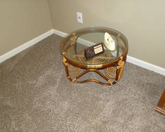 Round glass topped rattan table that matches that rocking chair, perfectly. A duet made in rattan heaven