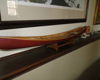Long hand carved miniature canoe