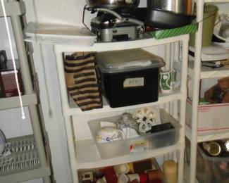 Shelves, filled with lots and lots of candles, and other kitchen items too
