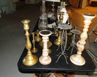 Candlesticks, some in brass, some in wood, some in metal and some in glass