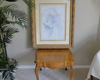 Framed artwork and wonderful detail in that side table too