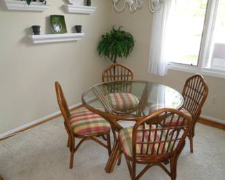 Glass and Rattan table and chairs, and the area rug is for sale too