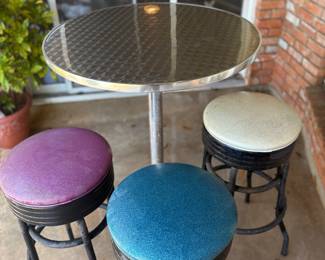 Hightop Table with 3 colorful chairs