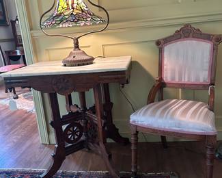 Eastlake "Wagon Wheel" table with marble top, Victorian Eastlake side chair. Tiffany style stained glass brass table lamp.