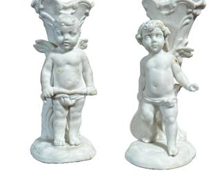 (2pc) PAIR PORCELAIN CUPID BUD VASES | Pair of porcelain bud vases with Cupid figure, each numbered on the bottom. - h. 4.5 x w. 2 x d. 2.75 in