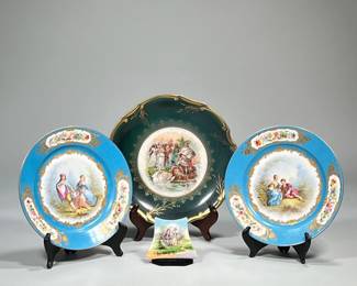 (4pc) Decorative Plates | Two blue compatible plates with courting couples in center and gold accents. Both plates are marked. Larger green plate with gold trim and Roman scene with Swan in center. Plate is marked. Small Lenox porcelain piece with courting couple depicted. - dia. 11 in (Largest)