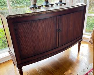 Granite top bow front sideboard with 2 interior drawers with silver storage. 2 reeded doors. 51w x 20.5d x 38h