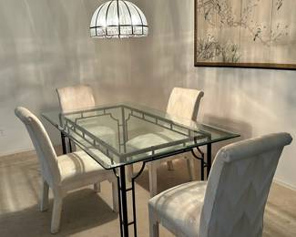 Glass and metal dining room set with four upholstered chairs