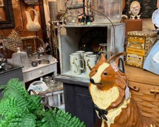 Large dog statue, old bottles and mugs, glassware.