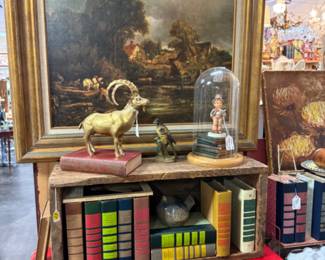 Brass figurines, framed art, old books.