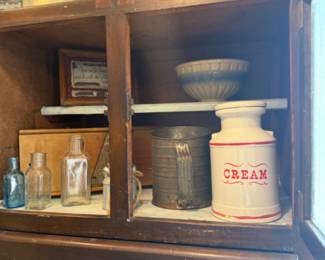 Old pie safe, sifter, bowls and larger ceramic cream pottery.