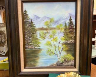 Vintage oil of water and trees, signed.