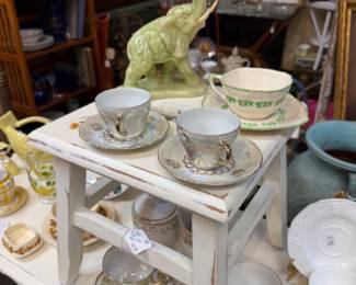 Elephant figurine, cups and saucers, candlesticks and vintage oil paintings.