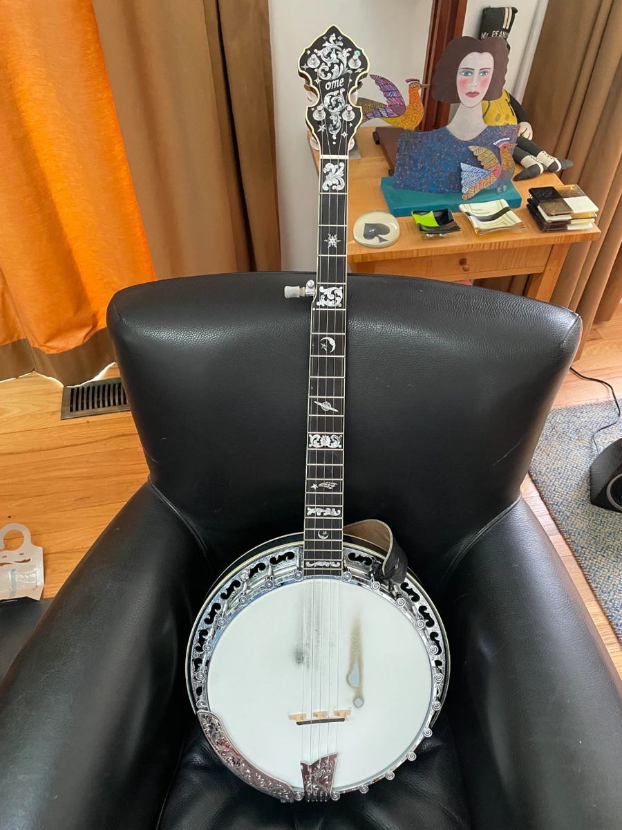 5-string bluegrass banjo, a top-tension monster that Ome Banjos (now owned by Gold Tone) custom built for client around 2005. Ideal for gigging musicians, although it has such a sparkling, deep tone it would be fun for a beginner to play in any setting. It also is pricey, as banjos go, mainly because it is elaborately decorated. Client paid $8,800 when special-ordered. Will include 3 lessons.