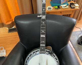 5-string bluegrass banjo, a top-tension monster that Ome Banjos (now owned by Gold Tone) custom built for client around 2005. Ideal for gigging musicians, although it has such a sparkling, deep tone it would be fun for a beginner to play in any setting. It also is pricey, as banjos go, mainly because it is elaborately decorated. Client paid $8,800 when special-ordered. Will include 3 lessons.