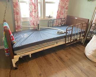 Hospital bed with overhanging bar for pulling up and adjustable top and bottom