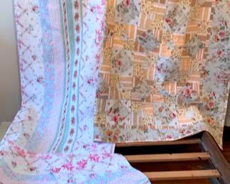 Two Quilts Pastel Floral Stripes and Blue and Taupe Squares.